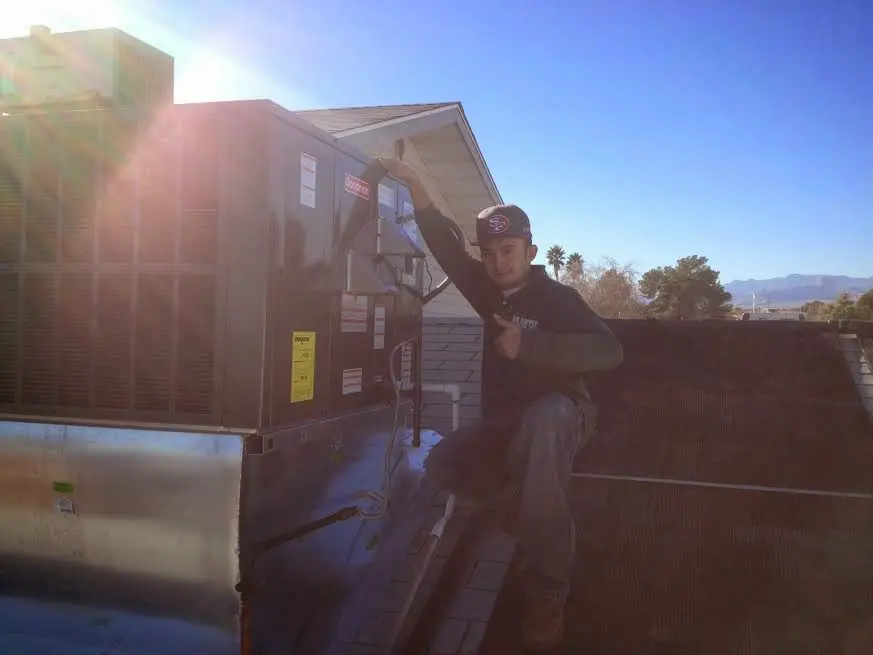 HVAC technician performing HVAC Inspection on a rooftop unit in Johnsburg